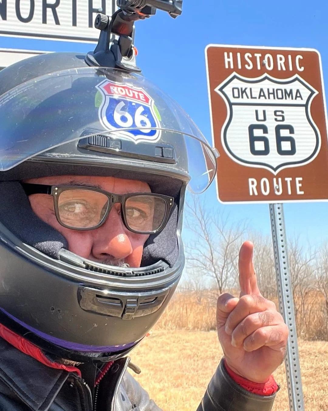 Pointing to the iconic Route 66 sign in Oklahoma - History of the road