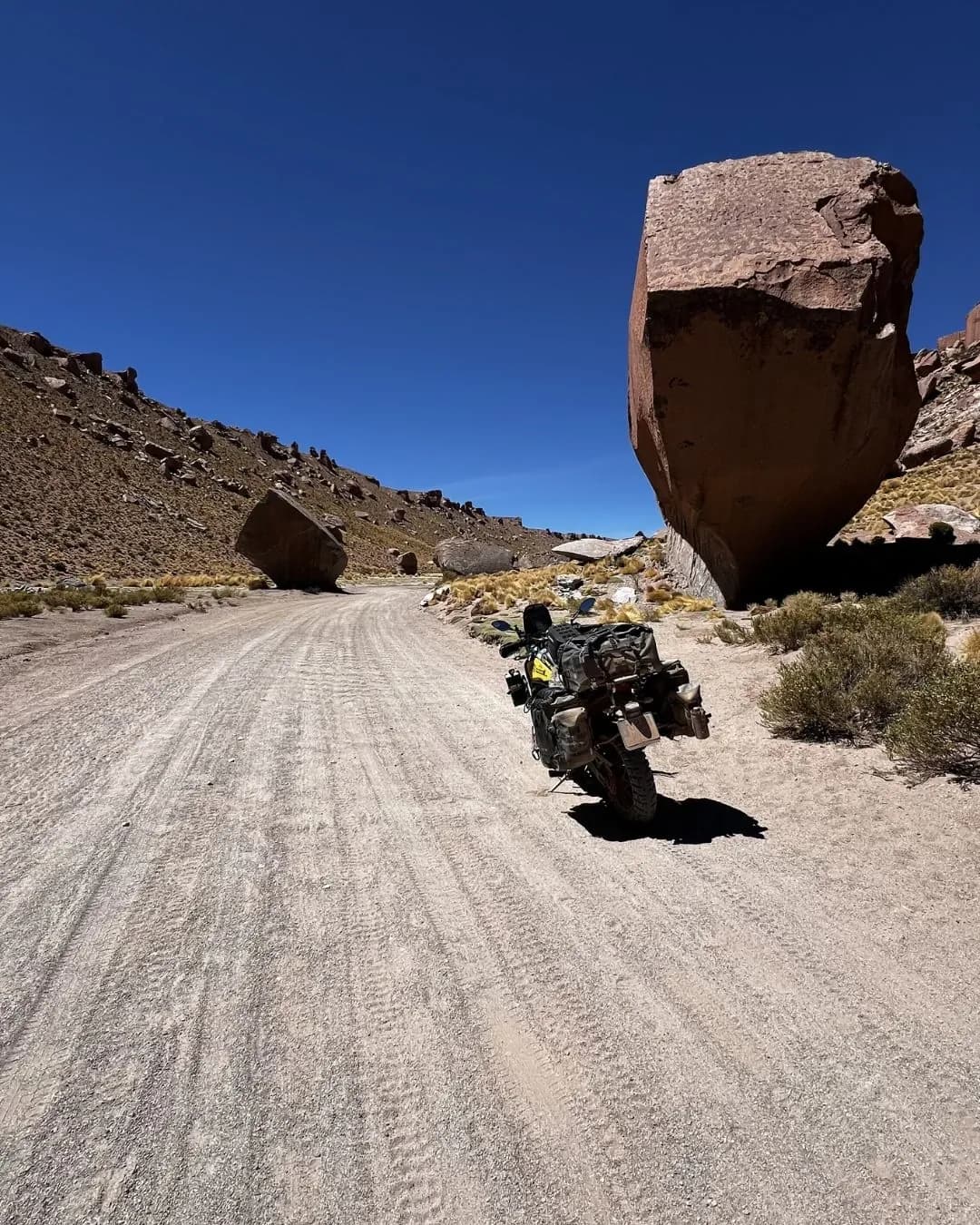 Motorcycle on gravel road through a rocky canyon - Route 40